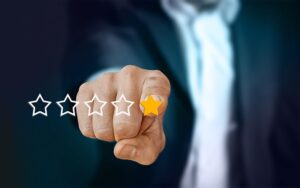 A man in a suit pointing to a one-star customer service.