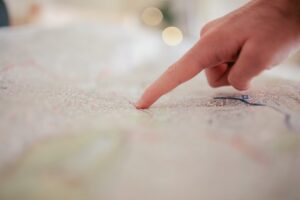 Finger pointing to a place on a map
