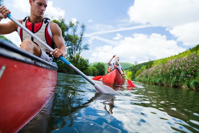 Two men in kayaks on a river.