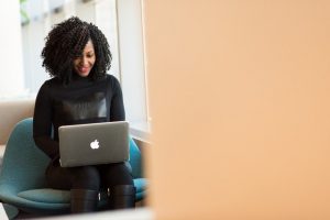 A woman looking at a laptop