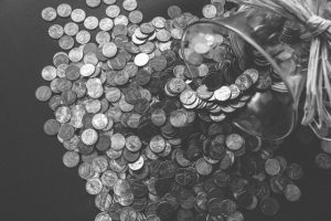 A gray image of pennies and a jar.